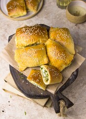 Russian Patties Pasties, Hot Cakes, Pirozhki, Pies on wooden cupboard . Traditional homemade fried pies.