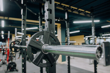 Panoramic shot of woman working out with barbell in gym