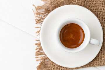 Cup of espresso coffee on saucer close up