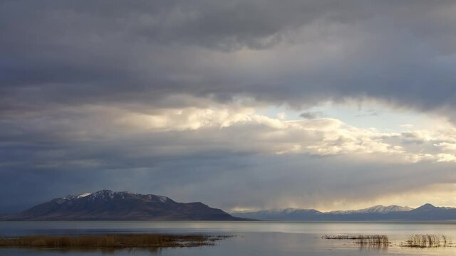 Time lapse of storm clouds moving over Utah Lake at dusk.