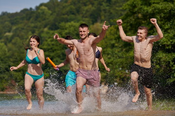 group of happy friends having fun on river