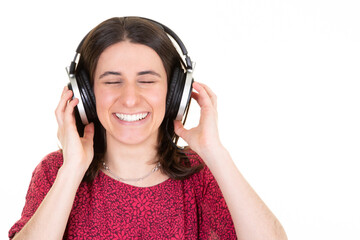 young woman enjoys musicians music in headphones on white background