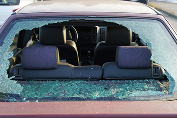 Broken rear window in car during accident or theft, thief smashed window and stole valuable items...