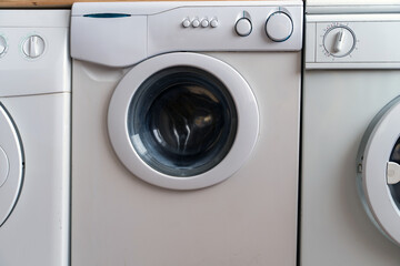 White washing machines in the laundry room, close-up