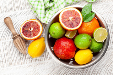 Various fresh citrus fruits in colander. Bood orange, lime, lemon