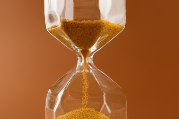Close up of sandglass on paper background