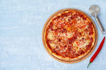 Delicious pizza with sausages on gray background