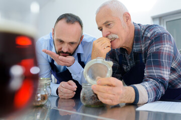 men smelling wood in wine house