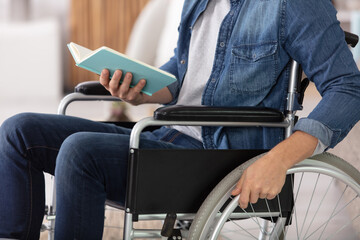 hands of young disable man holding book