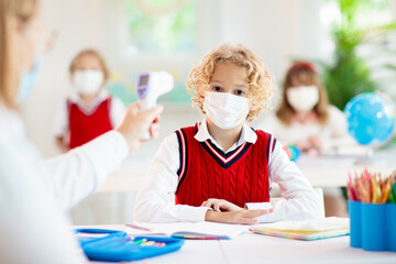 Temperature check in school. Child in face mask.