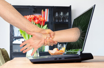 Man pulling someone through the laptop screen
