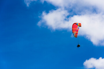 Paragliding extreme Sport with blue Sky and clouds on background Healthy Lifestyle and Freedom concept