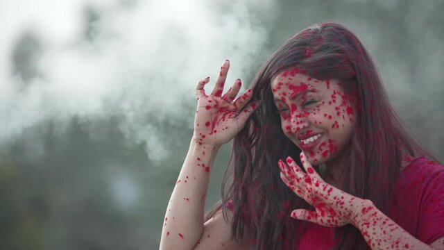 Indian Festival Holi Celebration Slowmotion.Indian Girl playing with colors, enjoying a festival of Colors Holi. High-quality 4k footage