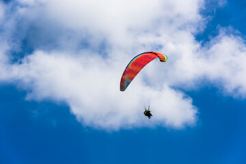 Paragliding extreme Sport with blue Sky and clouds on background Healthy Lifestyle and Freedom concept