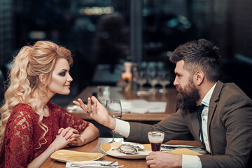 Young couple in a restaurant. Romantic couple dating in pub.