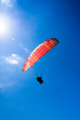 Paragliding extreme Sport with blue Sky and clouds on background Healthy Lifestyle and Freedom concept
