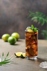 Cuba libre cocktail with lime and ice. Copy space for text.  Summer refreshing drink