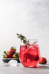 Pink drink with crushed ice and thyme. Strawberry and blueberry lemonade. Summer refreshing drink