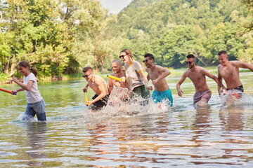 group of happy friends having fun on river
