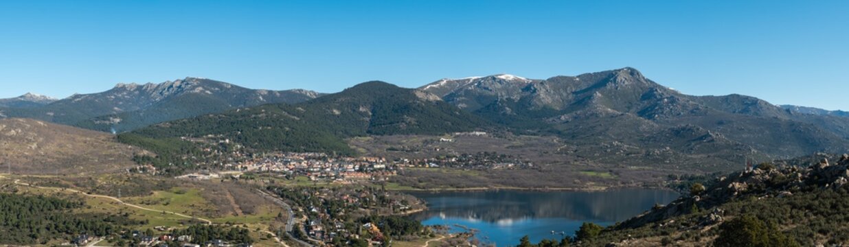 Panoramic view of the lake and the village of Navacerrada in the Community of Madrid with the Sierra de Guadarrama in the background - Siete Picos - Bola del Mundo - La Maliciosa