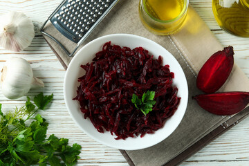 Concept of tasty eating with beet salad on white wooden background
