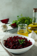 Concept of tasty eating with beet salad on white wooden background