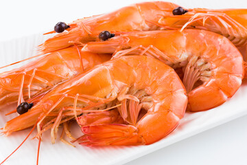 The cooked shrimp in a white dish