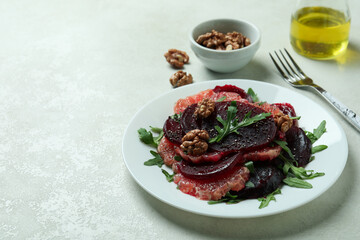 Concept of tasty eating with beet salad on white textured background