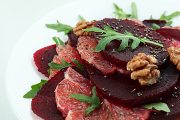 Beet salad with grapefruit on white background, close up