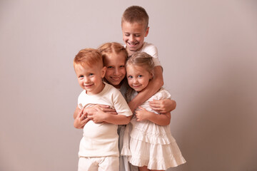 brothers and sisters. children hug. 4 children. large family