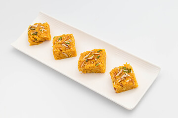 Sindhi Indian Mithai Sev Badam Halwa Burfi Barfee Or Barfi Is Made Of Bengal Gram Flour Besan Kaju Kesar Pista Khoya Meetha Doodh Mawa Malai In Desi Ghee. Isolated On White Background With Copy Space