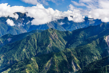 Layers of magnificent mountains and clear clouds background in the morning 