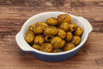Green grilled olives in the bowl