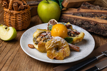 Dessert with baked apple, cinnamon, raisins and ice cream
