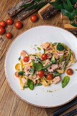 Salmon baked in a salad with tomatoes, basil and beans
