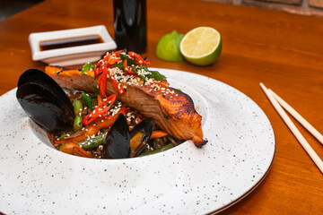 Traditional asian noodles with salmon and mussels
