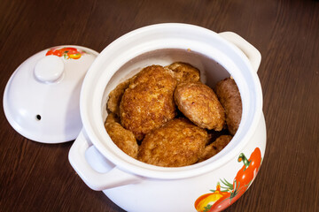 Delicious fried cutlets in a ceramic pot