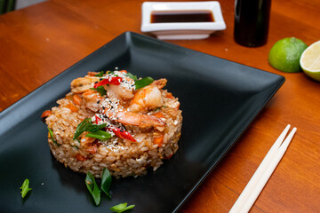 fried rice with shrimp, asian food on wooden table