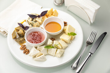 Plate with assorted cheeses and honey
