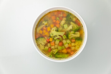 Soup in a white plate and a white background
