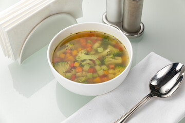 Soup in a white plate and a white background
