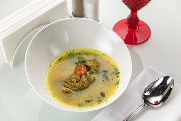 Soup in a white plate and a white background
