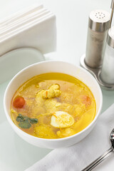Soup in a white plate and a white background
