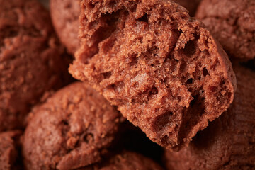 Half a chocolate cupcake on the background of others, selective focus, close up food background