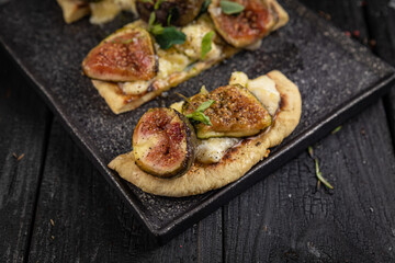 cocktail and food on a dark table
