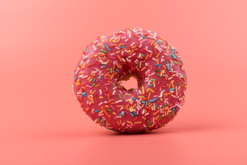 Fresh made Donuts isolated on pink background. Doughnuts are traditional sweet pastries. Copy space for text.