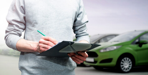 car service, repair, maintenance concept -  mechanic writing to the clipboard at workshop warehouse, technician doing the checklist for repair machine a car in the service, detailing