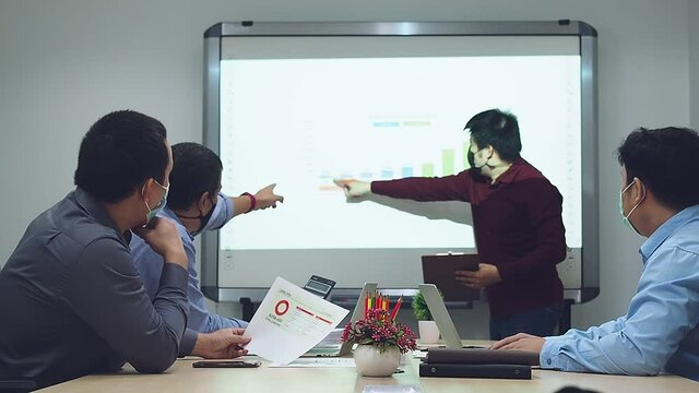 Businessmen Wearing Protective Masks Discussing And Work Together In Meeting Room. Social Distance Practice Prevent Coronavirus COVID-19.