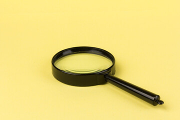 magnifying glass  loupe search symbol on yellow background with copy space