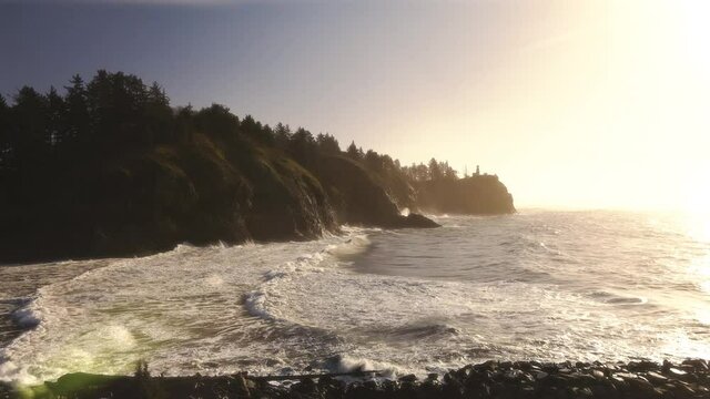 Golden Sunlight Aerial of Ocean Waves Splashing at Cape Disappointment Lighthouse